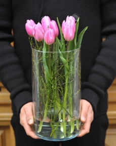 Flower arrangement with 9 pink tulips in glass vase