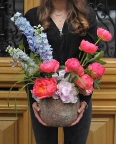Flower arrangement with peonies and hydrangeas in ceramic bowl