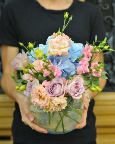 Summer flowers arrangement in glass vase 