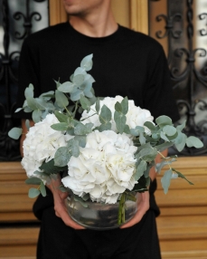 Elegant flower arrangement with hydrangea in glass bowl