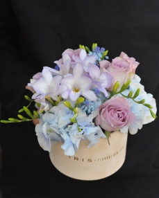 Flower arrangement with hydrangea, freesia and roses