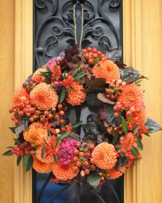 Autumn wreath with dahlias and rosehips 