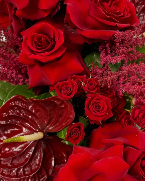 Funeral arrangement with roses and anthurium